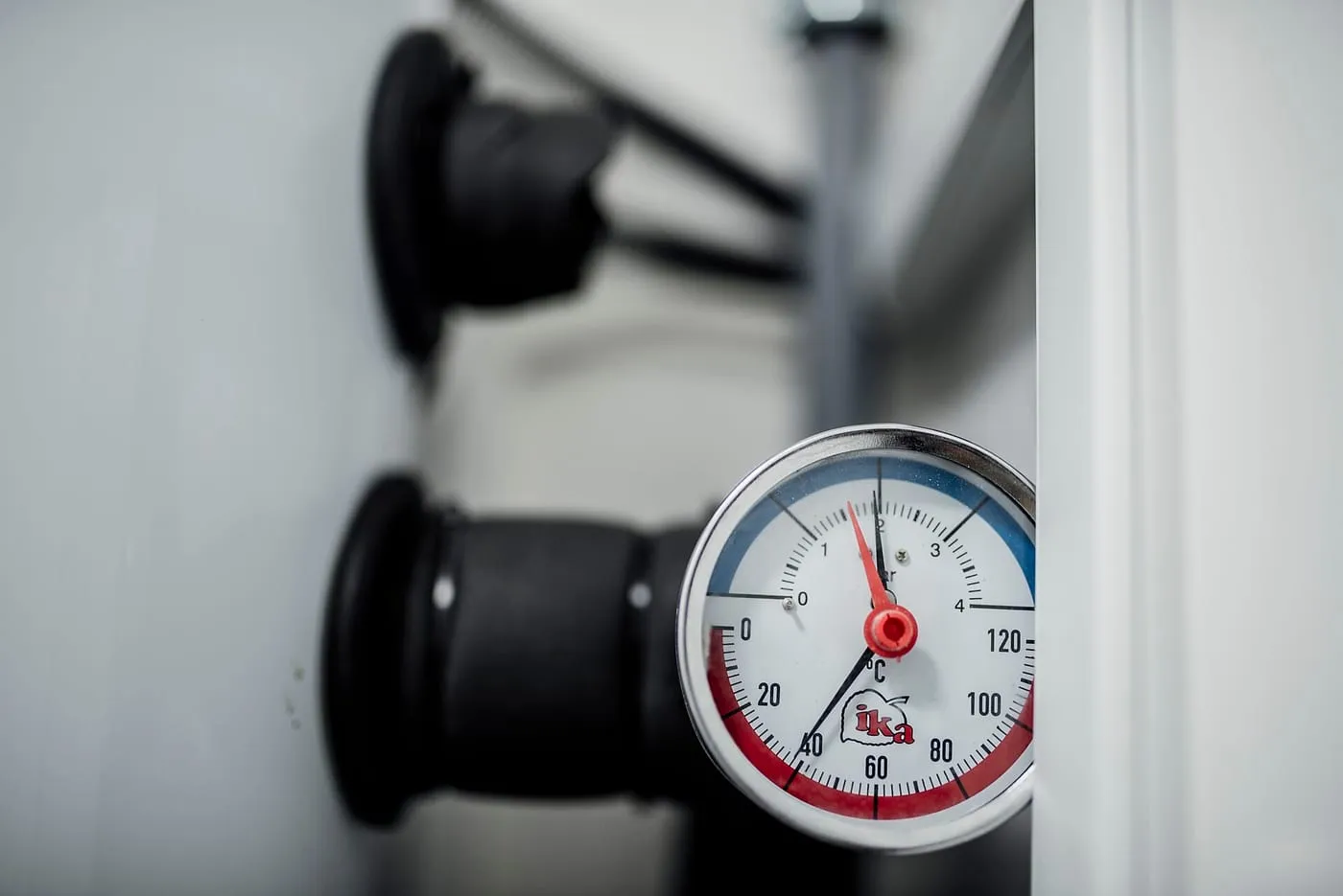 A heating system pressure and temperature gauge on a pipe