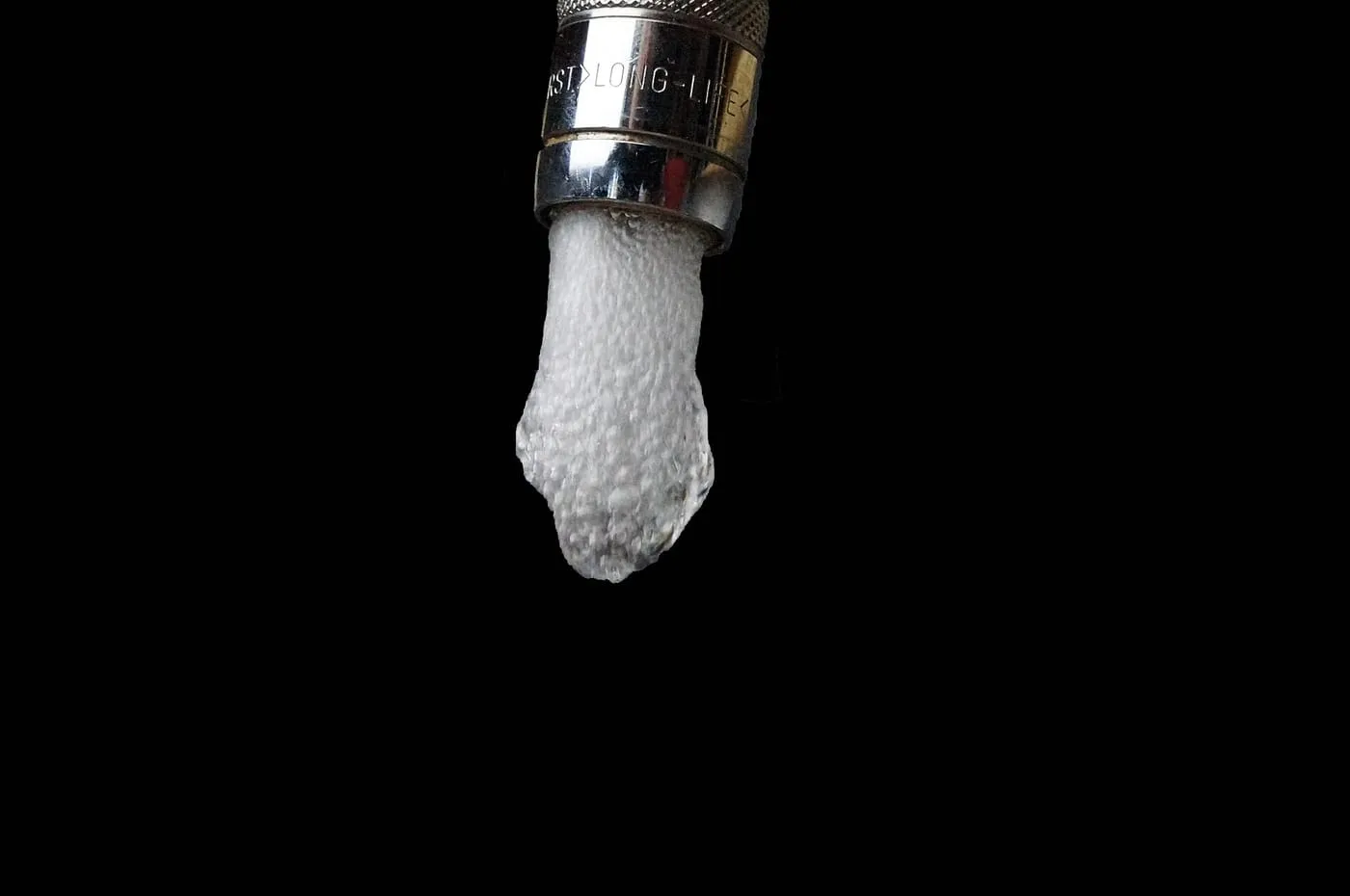Water spluttering from a tap as it starts to flow