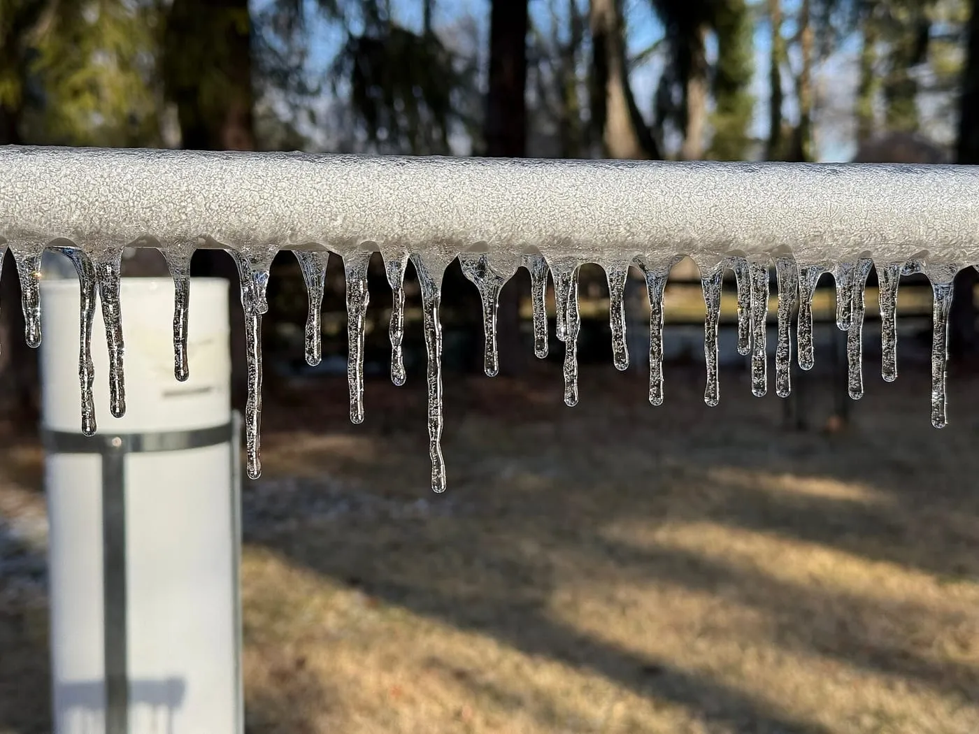 Icicles hanging from an outdoor pipe after freezing rain
