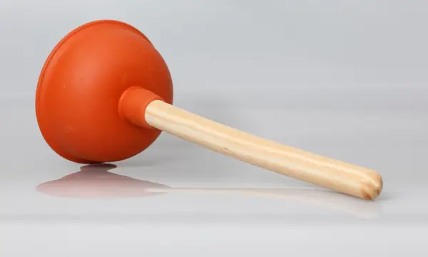 A rubber sink plunger with a wooden handle