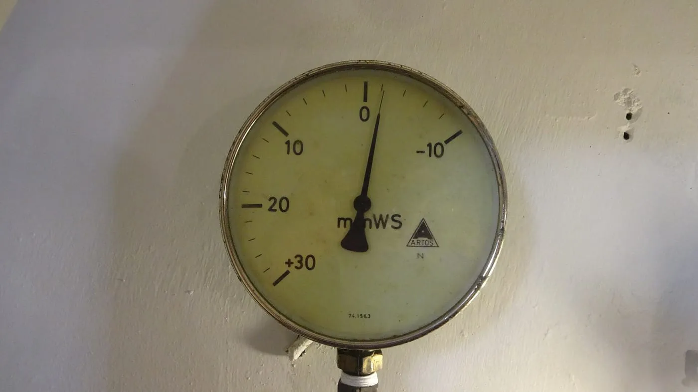 A pressure gauge mounted on a wall