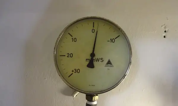 A pressure gauge mounted on a wall