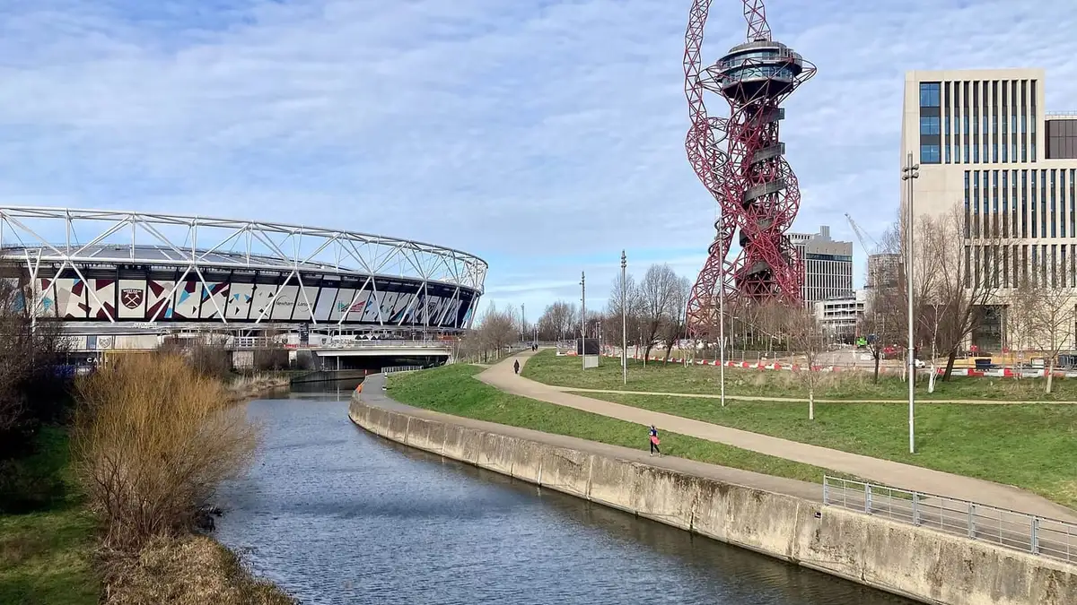 The River Lea in Queen Elizabeth Olympic Park, Stratford, with the London Stadium and Orbit