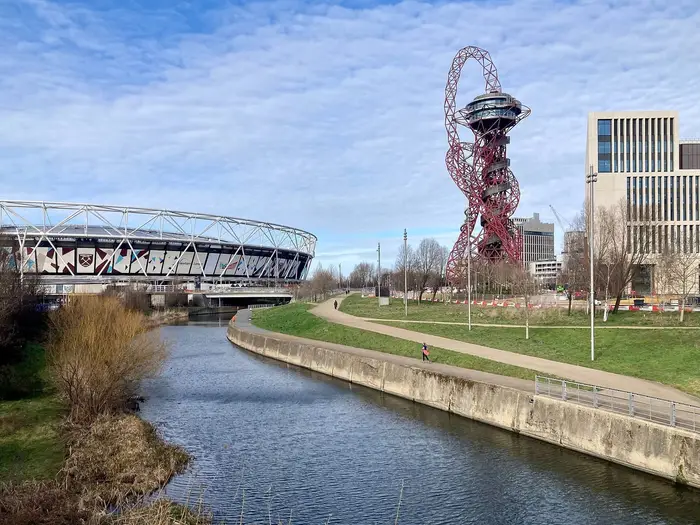 The River Lea in Queen Elizabeth Olympic Park, Stratford, with the London Stadium and Orbit