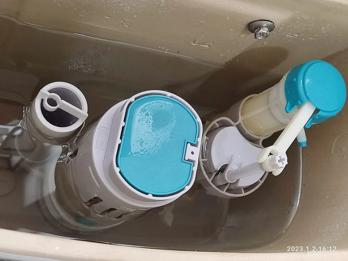 Inside a toilet cistern: the flush valve and fill valve