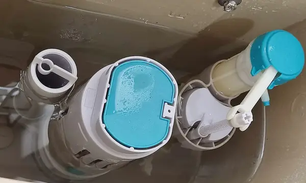 Inside a toilet cistern: the flush valve and fill valve