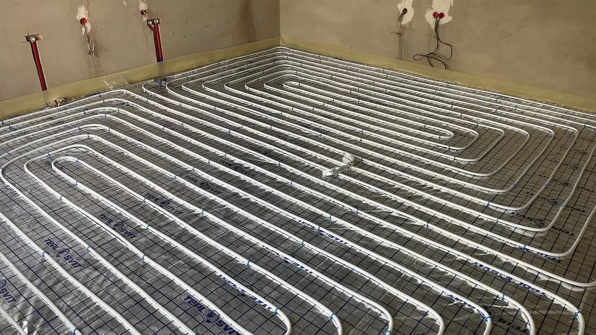 Underfloor heating pipes laid in loops across a floor before screeding